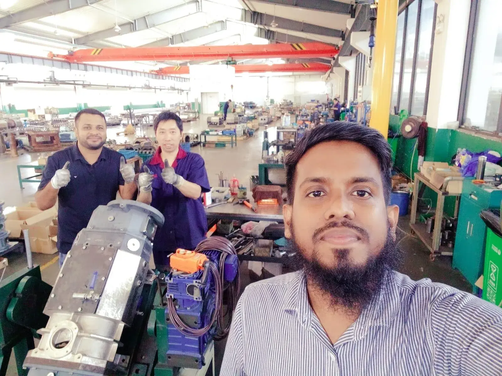 Team members in a blower assembly workshop with a partner technician