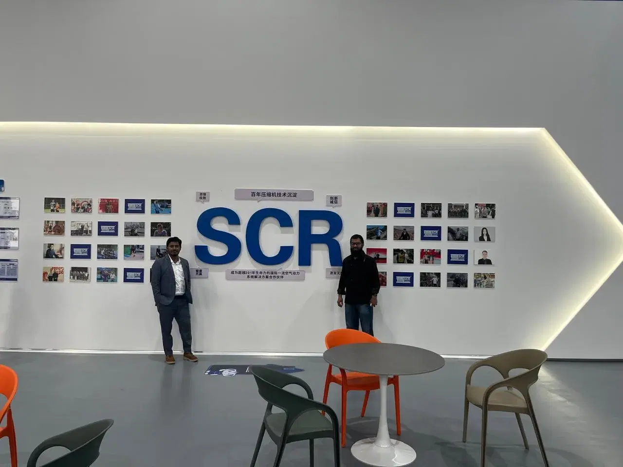 Team members at the SCR brand wall during a factory visit